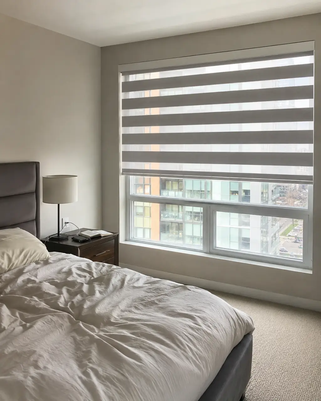 Blackout zebra shades installed in a bedroom for privacy and room darkening