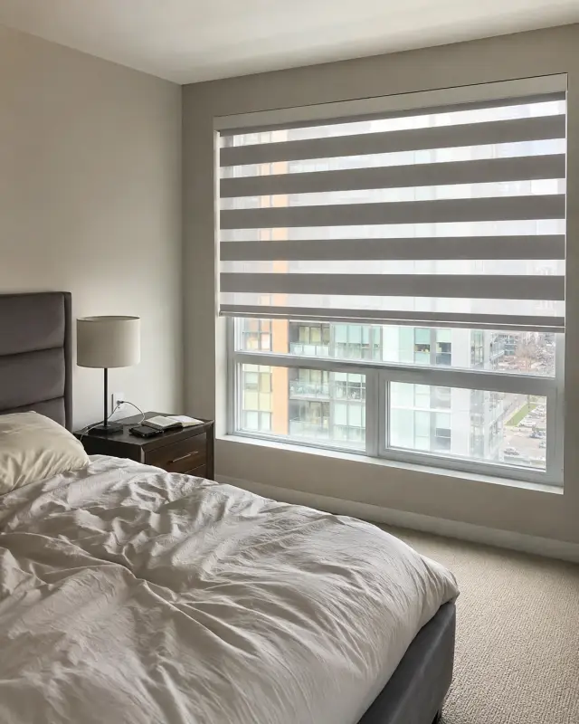 Blackout zebra shades installed in a bedroom for privacy and room darkening